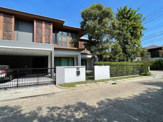 Modern two-story house exterior with balcony and carport