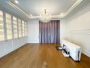 Spacious living room with hardwood floors and crystal chandelier