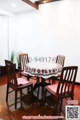 Cozy dining room with wooden chairs and a table with a decorative tablecloth