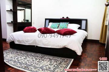 Cozy bedroom with a large bed and wooden flooring