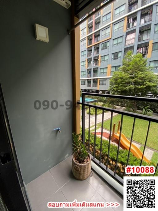 Compact balcony with a view of apartment building and greenery