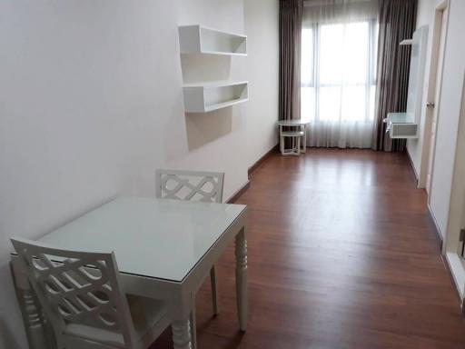 Spacious dining room with laminate flooring and natural light