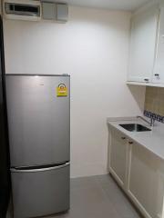 Modern kitchen with stainless steel refrigerator and small sink