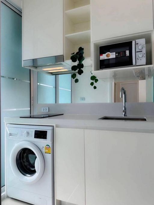 Modern kitchen with built-in appliances and white cabinetry