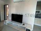 Modern living room interior with wall-mounted TV and air conditioning unit