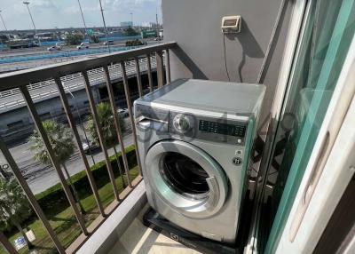 Washing machine on balcony with view of an outside area