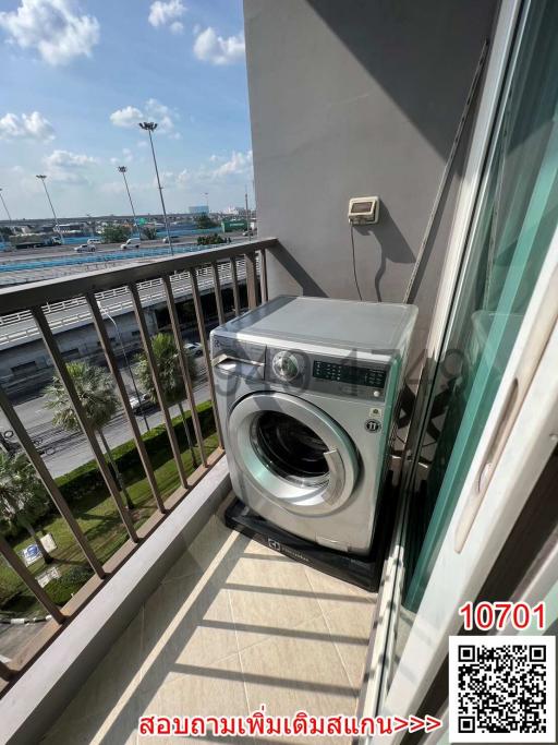 Washing machine on balcony with view of an outside area