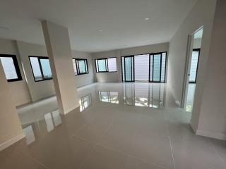 Spacious and bright empty room with large windows and glossy tiled floor