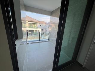 Balcony view of a residential building with glass railing and tile flooring