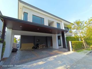 Modern two-story house with carport and lawn