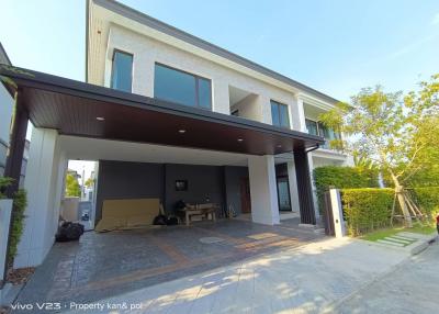 Modern two-story house with carport and lawn