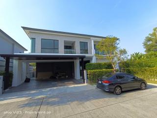 Contemporary two-story house with a carport and a car parked outside