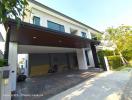 Contemporary two-story house with spacious front yard and parking space