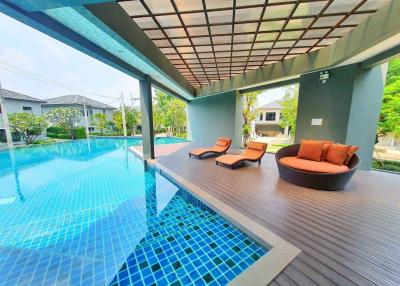 Luxurious poolside area with lounge chairs