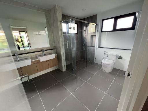 Spacious modern bathroom with glass shower enclosure and double vanity