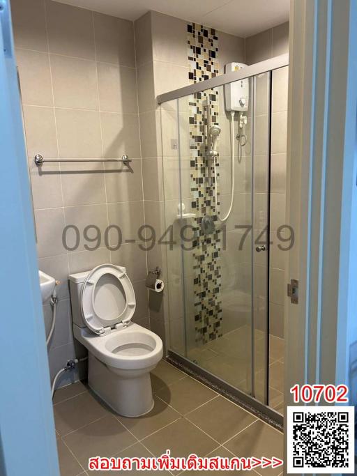 Modern bathroom with glass shower enclosure and tiled walls