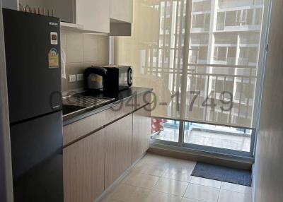 Modern kitchen with stainless steel appliances and large windows