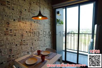 Cozy dining space with patterned wallpaper and balcony access