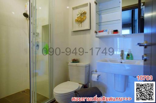 Modern bathroom interior with glass shower and white furnishings