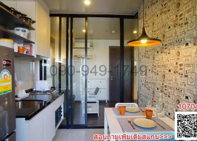 Compact modern kitchen with decorative wallpaper and equipped with contemporary amenities