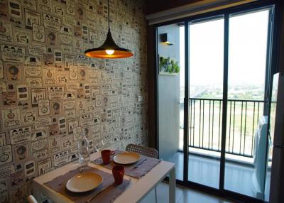 Modern dining area with unique wallpaper and balcony access