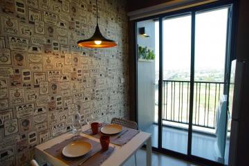 Modern dining area with unique wallpaper and balcony access