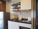 Compact modern kitchen with built-in appliances and floating shelves