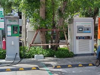 Electric vehicle charging station in a parking area