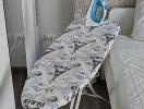 Iron and ironing board in a modern bedroom setting