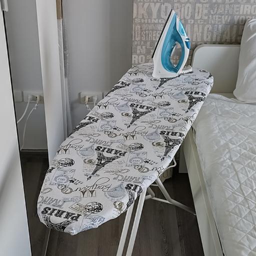 Iron and ironing board in a modern bedroom setting