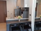 Modern kitchen with stainless steel appliances and breakfast bar