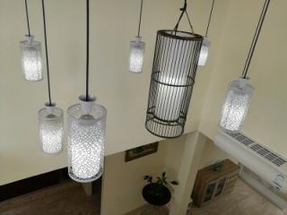 Elegant pendant lights hanging in a modern hallway with neutral color palette