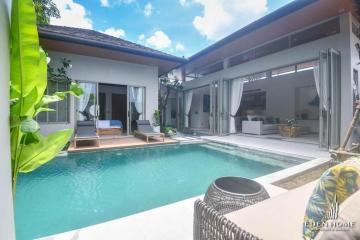 Luxurious poolside outdoor living area with open patio doors