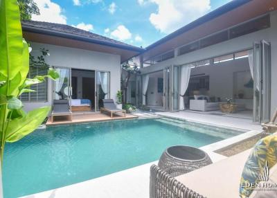 Luxurious poolside outdoor living area with open patio doors