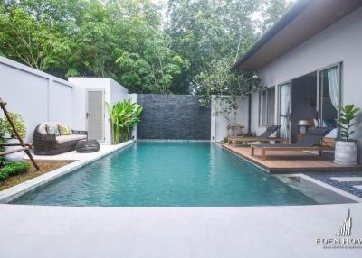 Private pool with adjoining patio in a serene backyard setting