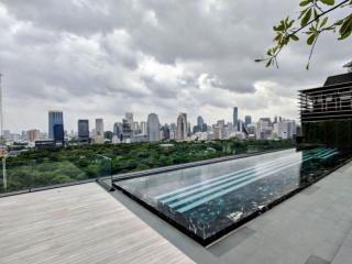 Panoramic city view from a high-rise balcony with glass balustrades