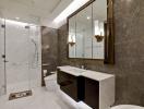 Modern bathroom with marble tiles, large mirror, and glass shower