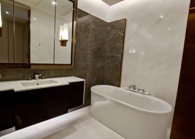 Modern bathroom with a large mirror and elegant bathtub
