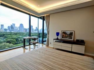 Modern bedroom with large windows and a city view