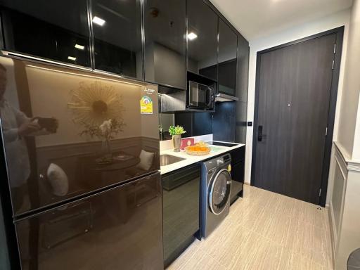 Modern kitchen with stainless steel appliances and wood flooring