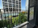 Spacious balcony with city view and greenery