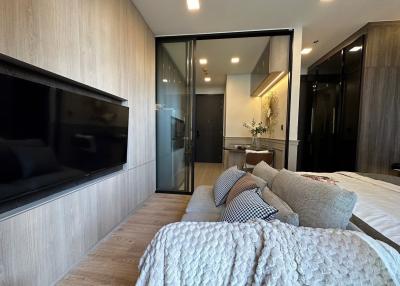 Cozy modern bedroom with attached bathroom and a flat-screen TV