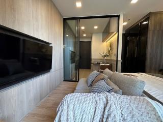 Cozy modern bedroom with attached bathroom and a flat-screen TV
