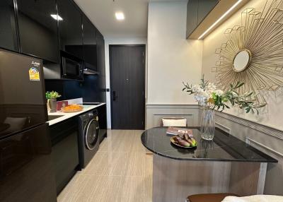 Modern kitchen with dark cabinetry and stylish decor
