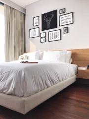 Modern bedroom interior with large bed and wall art