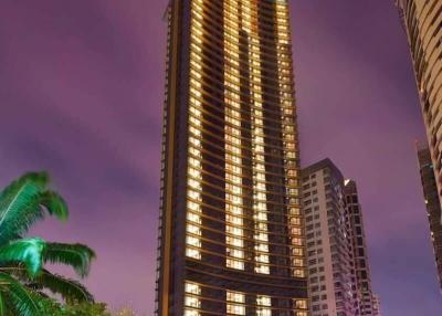 High-rise residential tower at dusk with illuminated windows