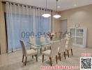 Elegant dining room with glass table and comfortable chairs