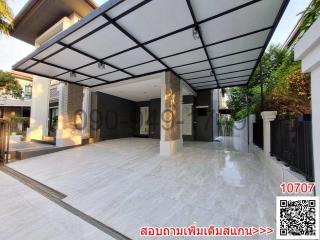 Spacious tiled driveway with covered parking area in a modern residential house