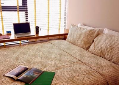 Cozy bedroom with a large bed and a work desk by the window