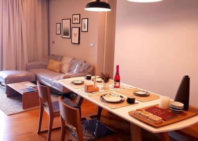 Modern dining room with set table and an adjacent living area